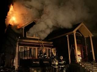 FF's raise ladder to second floor at Deer Park Tavern Fire, Katonah. Photo by Frank Becerra. (1/26/10)